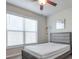 Cozy bedroom with large window, ceiling fan, and ample natural light at 1868 Lakeview Bend Way, Buford, GA 30519