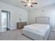 Bright bedroom with ceiling fan, plush carpet, and plenty of closet space at 1868 Lakeview Bend Way, Buford, GA 30519