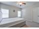 Spacious bedroom with ceiling fan, carpet flooring, and ample natural light at 1868 Lakeview Bend Way, Buford, GA 30519