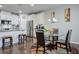 Kitchen breakfast nook with glass table and four leather chairs at 1868 Lakeview Bend Way, Buford, GA 30519