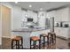 Modern kitchen with white cabinets, granite island, and stainless steel appliances at 1868 Lakeview Bend Way, Buford, GA 30519
