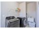 Functional laundry room with washer, dryer, and utility sink at 1868 Lakeview Bend Way, Buford, GA 30519