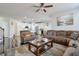 Spacious living room featuring a comfortable sectional sofa and large windows at 1868 Lakeview Bend Way, Buford, GA 30519