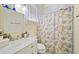 Charming bathroom with seashell shower curtain and white vanity at 2195 Morgan Ne Rd, Marietta, GA 30066