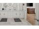 Double vanity bathroom with marble countertops and grey tile floors at 2195 Morgan Ne Rd, Marietta, GA 30066