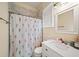Bathroom with floral shower curtain and white vanity with quartz countertop at 2195 Morgan Ne Rd, Marietta, GA 30066