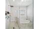 Bathroom with glass shower, soaking tub, and marble tile at 2195 Morgan Ne Rd, Marietta, GA 30066
