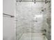 Bathroom with marble tile shower/tub combo, glass door, and modern fixtures at 2195 Morgan Ne Rd, Marietta, GA 30066