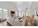 Open Gathering room with hardwood floors, sectional sofa, and stone fireplace at 2195 Morgan Ne Rd, Marietta, GA 30066