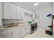 Laundry room with white cabinets, granite countertops, and washer/dryer at 2195 Morgan Ne Rd, Marietta, GA 30066