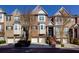 Brick townhouses with attached garages and landscaping at 2969 Rivergreen Se Ln, Atlanta, GA 30339