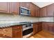 Stainless steel appliances and granite countertops in this kitchen at 2969 Rivergreen Se Ln, Atlanta, GA 30339