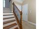 Staircase with wooden handrail and carpet at 2969 Rivergreen Se Ln, Atlanta, GA 30339