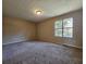 Spacious carpeted bedroom with large window and neutral walls at 3140 Shadow Walk Ln, Tucker, GA 30084