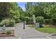 Concrete path lined with mature greenery, a fire hydrant, and a dog waste station at 504 Rankin Ne St # 4, Atlanta, GA 30308