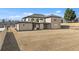 Expansive backyard featuring a brick home with a covered patio and ample space for outdoor activities at 2753 Camp Branch Rd, Buford, GA 30519