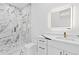 Modern bathroom featuring marble-style walls, a glass shower, a sleek vanity, and contemporary fixtures at 2753 Camp Branch Rd, Buford, GA 30519