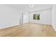 Spacious bedroom with light hardwood floors, large windows, white walls and doors, and modern recessed lighting at 2753 Camp Branch Rd, Buford, GA 30519
