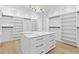 Custom walk-in closet with ample shelving and storage, plus central island with stone countertop at 2753 Camp Branch Rd, Buford, GA 30519