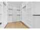 Well-organized walk-in closet featuring built-in shelves and hanging rods for optimal storage at 2753 Camp Branch Rd, Buford, GA 30519