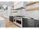 Close up of kitchen featuring stainless steel oven, marble countertops and backsplash, and custom cabinets at 2753 Camp Branch Rd, Buford, GA 30519