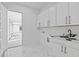 Clean and organized laundry room with white cabinets and countertop at 2753 Camp Branch Rd, Buford, GA 30519