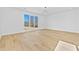 Bright and airy living room with light hardwood floors, large window, and sleek contemporary lighting at 2753 Camp Branch Rd, Buford, GA 30519