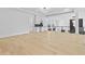 Open concept living space featuring light hardwood flooring, bar area, modern lighting and black iron railing at 2753 Camp Branch Rd, Buford, GA 30519