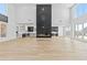 Expansive living room with a modern fireplace, high ceilings, and abundant natural light, open to the kitchen at 2753 Camp Branch Rd, Buford, GA 30519