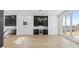 Open concept living room with large windows, custom cabinets, wine storage, and a view of the backyard at 2753 Camp Branch Rd, Buford, GA 30519