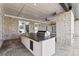 Covered outdoor kitchen with island, built-in grill, and fan at 2753 Camp Branch Rd, Buford, GA 30519