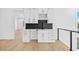Modern wet bar features white cabinets, black countertop and backsplash, wine rack, and a contemporary design at 2753 Camp Branch Rd, Buford, GA 30519