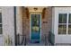 Close-up of a blue painted front door and brick facade with elegant design details at 3239 Bartee Walk, Suwanee, GA 30024