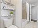 Clean bathroom with a tub shower, toilet and shelving unit at 1084 Fairburn Nw Rd, Atlanta, GA 30331
