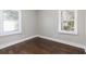 Bright bedroom with hardwood floors and two windows at 1084 Fairburn Nw Rd, Atlanta, GA 30331