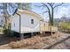 Rear view of a white house with a deck and trees at 1084 Fairburn Nw Rd, Atlanta, GA 30331