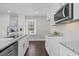 Modern kitchen with white cabinets, granite countertops and hardwood floors at 1084 Fairburn Nw Rd, Atlanta, GA 30331