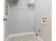 Laundry room with overhead shelving and tile floor at 1084 Fairburn Nw Rd, Atlanta, GA 30331
