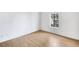 Simple bedroom with hardwood floors and large window at 2006 Augusta Se Dr, Marietta, GA 30067