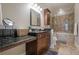 Well-lit bathroom with granite counters and a tiled shower and tub at 3635 E Paces Ne Cir # 1110, Atlanta, GA 30326