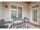 Covered outdoor patio with stylish seating, brick floor, and natural light at 3635 E Paces Ne Cir # 1110, Atlanta, GA 30326