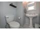 Cozy half-bathroom featuring a classic pedestal sink, modern fixtures, and gray walls at 54 Etham Pl, Douglasville, GA 30134