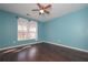 Bedroom with hardwood floors, a ceiling fan and a bright window at 54 Etham Pl, Douglasville, GA 30134