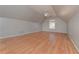 Large bonus room with hardwood flooring, natural light and ceiling fan at 54 Etham Pl, Douglasville, GA 30134
