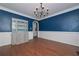Dining room showcasing elegant chandelier, chair rail trim, and rich hardwood floors at 54 Etham Pl, Douglasville, GA 30134