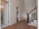 Bright foyer features an open staircase and view to the living room and half bathroom at 54 Etham Pl, Douglasville, GA 30134