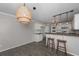 Eat-in kitchen with tile flooring, two bar stools, and neutral-toned cabinets at 54 Etham Pl, Douglasville, GA 30134