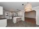 Open kitchen featuring tile flooring, white cabinetry, eat-in bar, and modern lighting fixtures at 54 Etham Pl, Douglasville, GA 30134
