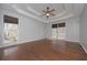 Spacious primary bedroom with hardwood floors, tray ceiling, and bright windows at 54 Etham Pl, Douglasville, GA 30134
