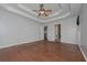 Large primary bedroom features tray ceilings, hardwood floors, and ensuite bath access at 54 Etham Pl, Douglasville, GA 30134